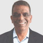 Stephen Lobo, founder of Magic Investing, sitting thoughtfully in his office surrounded by financial books and charts, representing decades of investing wisdom and patient wealth-building philosophy